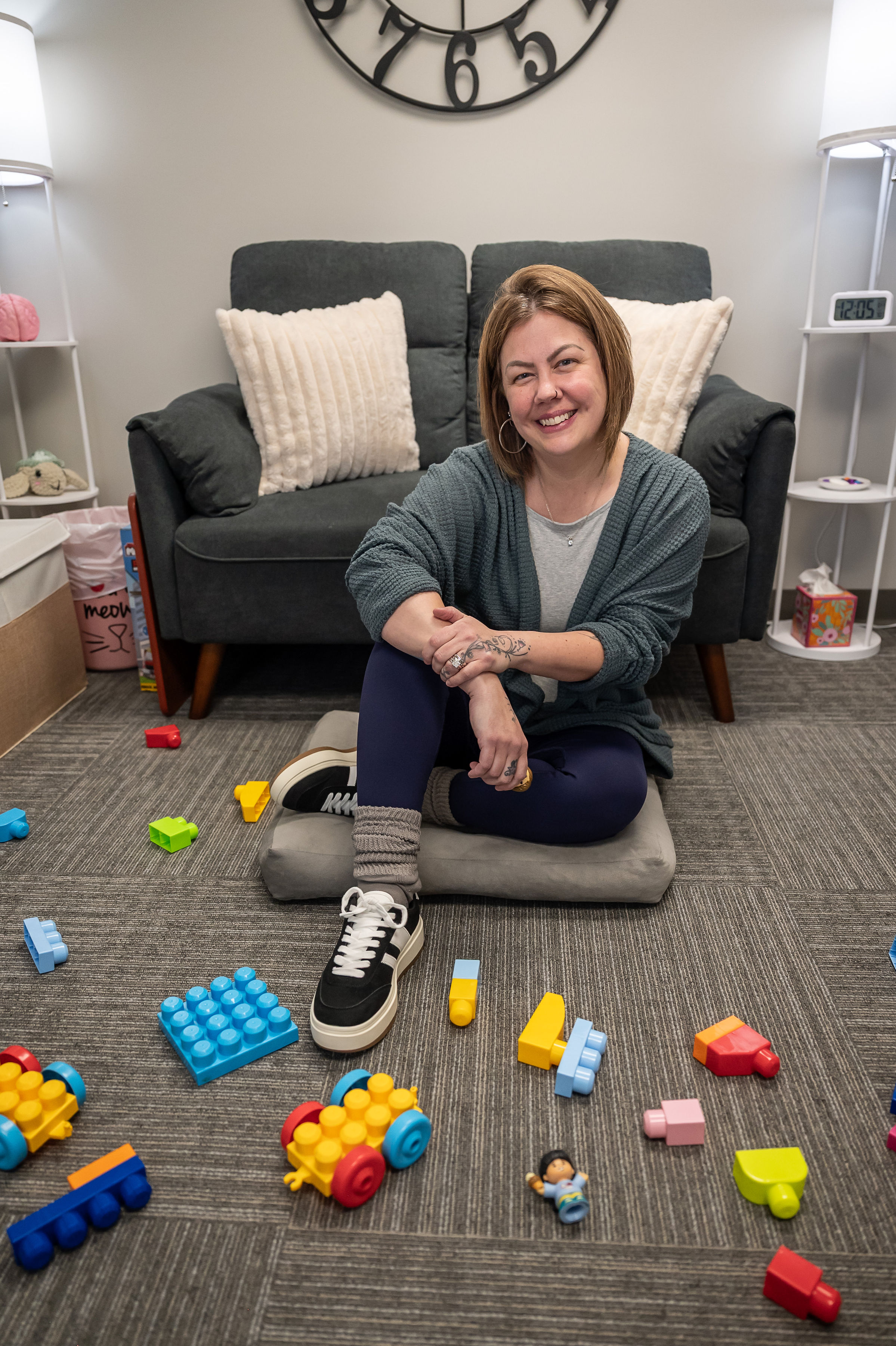 Misty sitting on the floor of her play room